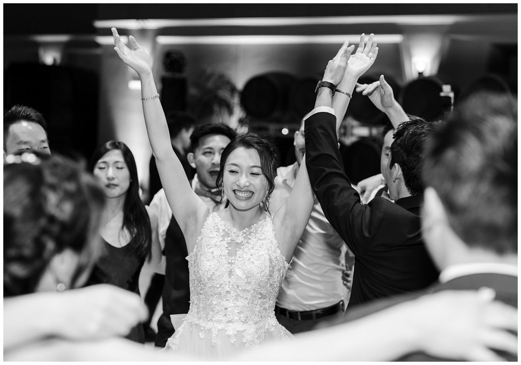 Bride cheering at the end of her Elegant Wedding in California