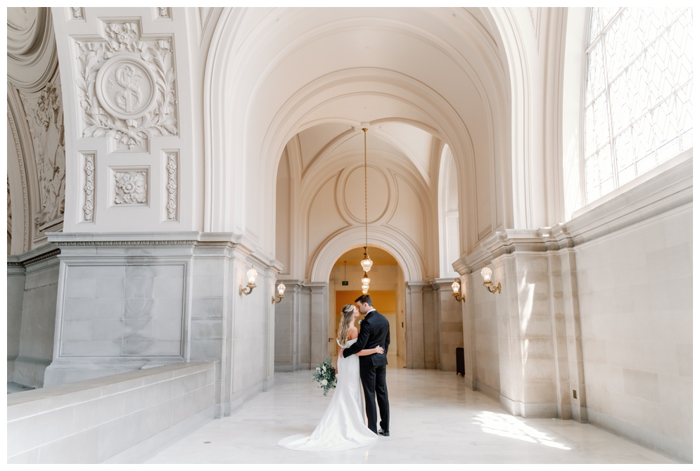Bride and Groom Kissing at Their 4th Floor Gallery Wedding at SF City Hall